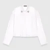 Camicia corta con dettaglio gioiello Camicia corta con dettaglio gioiello