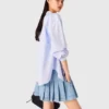 Gonna corta in denim a pieghe con strass Gonna corta in denim a pieghe con strass