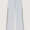 Jeans a zampa con strappi e strass Jeans a zampa con strappi e strass